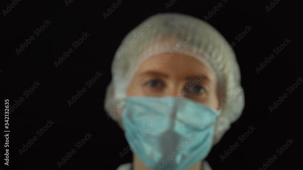 The doctor, a woman, holds a test tube with a positive coronavirus test in her hand and looks at it. New coronavirus pneumonia covid-19 (coronavirus). The doctor, a woman, holds a test tube with a positive coronavirus test in her hand and looks at it. New coronavirus pneumonia covid-19 (coronavirus).