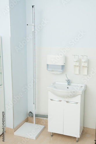 Sink and sanitizer in clinic. Medical equipment. Coronavirus pandemic