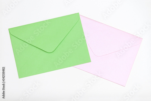 Green and pink envelopes on pastel background.