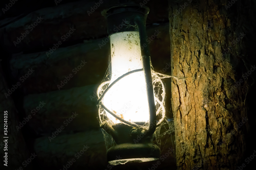 Miner's Lamp in Dark Mine on a Wood