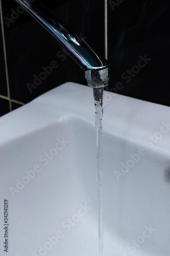 Tap water flows into the sink