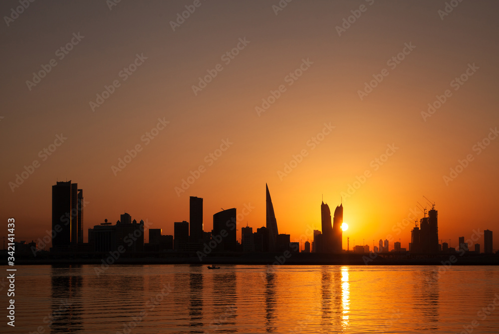 Bahrain skyline and fishing boat at sunset