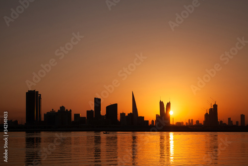 Bahrain skyline and fishing boat at sunset