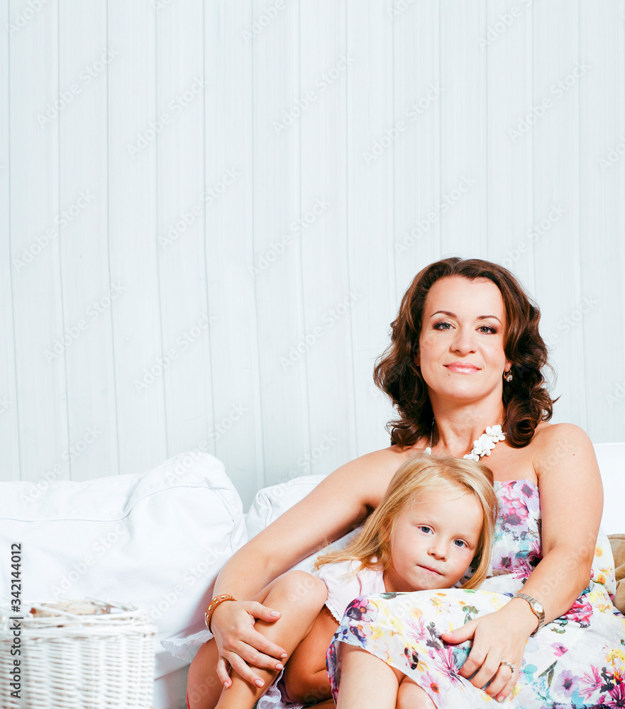 Portrait of smiling young mother and daughter at home, happy family together having fun, lifestyle people concept Portrait of smiling young mother and daughter at home, happy family together having fun, lifestyle people concept