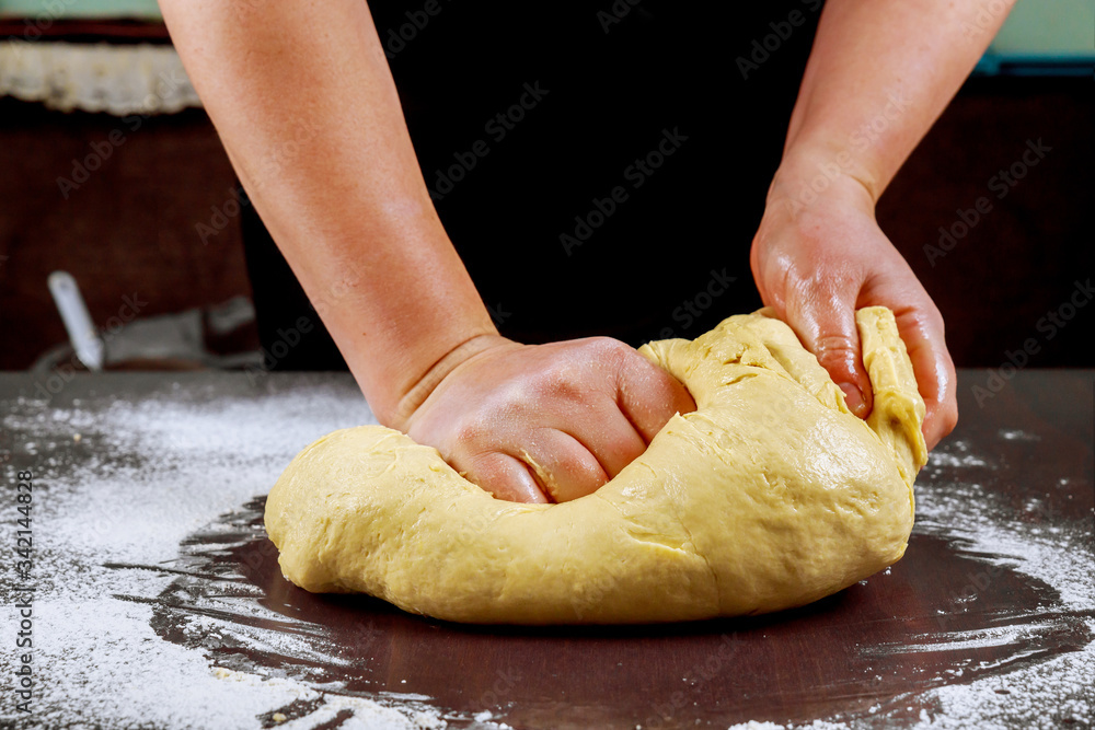 Woman kneading dough for making bread. Woman kneading dough for making bread.