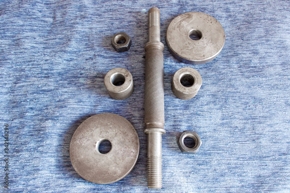 Disassembled metal dumbbell on the table Disassembled metal dumbbell on the table