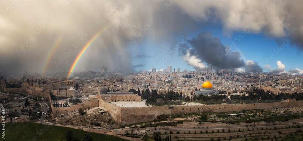 Fototapeta premium Beautiful panoramic aerial view of the Old City, Tomb of the Prophets and Dome of the Rock. Dramatic Rain and Rainbow Sky Composite. Jerusalem, Capital of Israel.