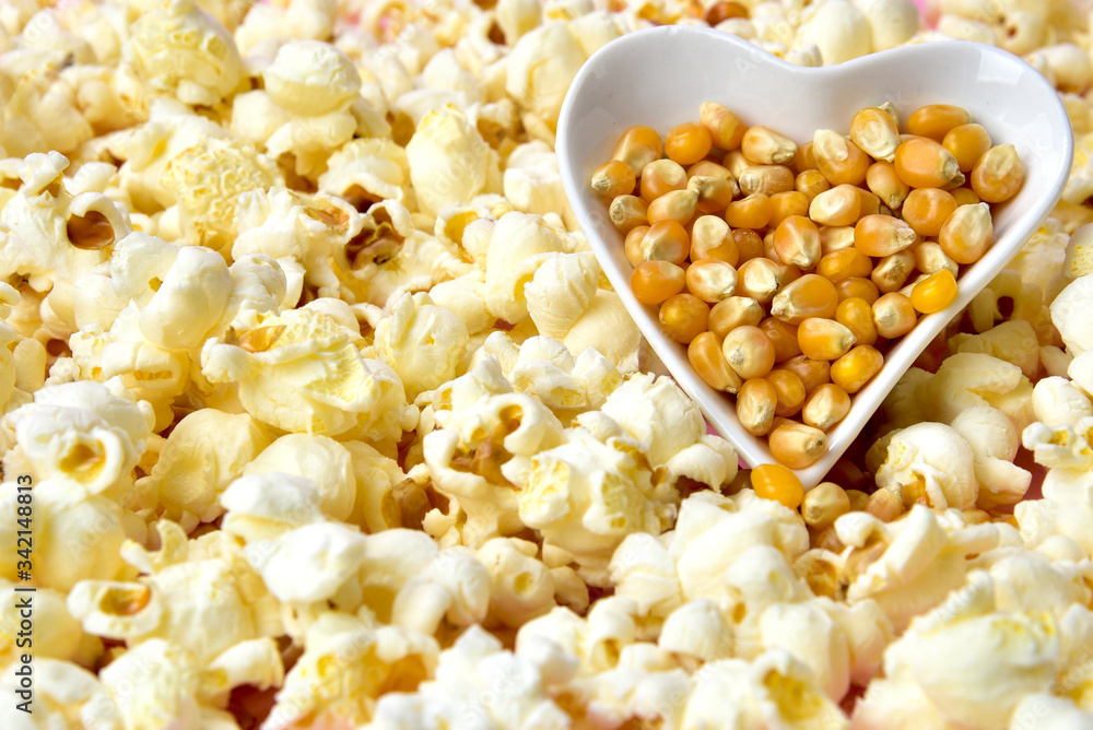 popcorn inside the heart shape bowl with space for text.typical brazilian june party popcorn inside the heart shape bowl with space for text.typical brazilian june party