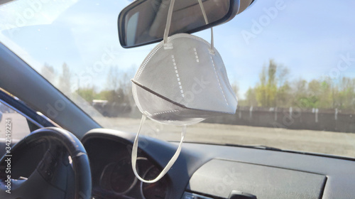 medical mask hanging in the car