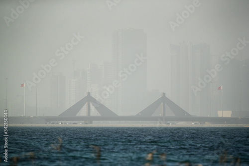 Sheikh Salman Causeway bridge and Bahrain skyline during duststorm photo