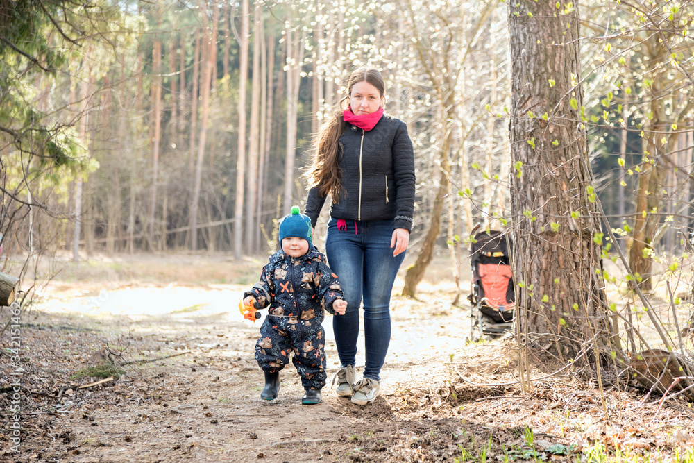 a girl with a child walking in the woods. Walking in the fresh air. Family in nature.