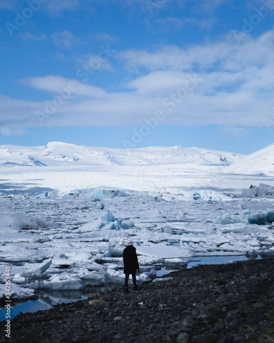Woman standing in front of Jökulsárlón glacier lagoon, Vatnajökull National Park, Iceland