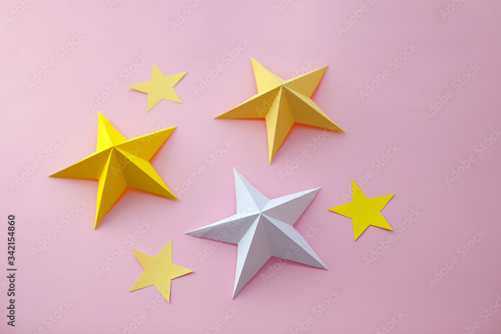 Handmade paper art and cut white and yellow stars on pink background. Handmade paper art and cut white and yellow stars on pink background.