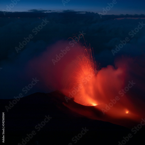 Red glowing lava eruption of volcano Stromboli during night, Sicily Italy.