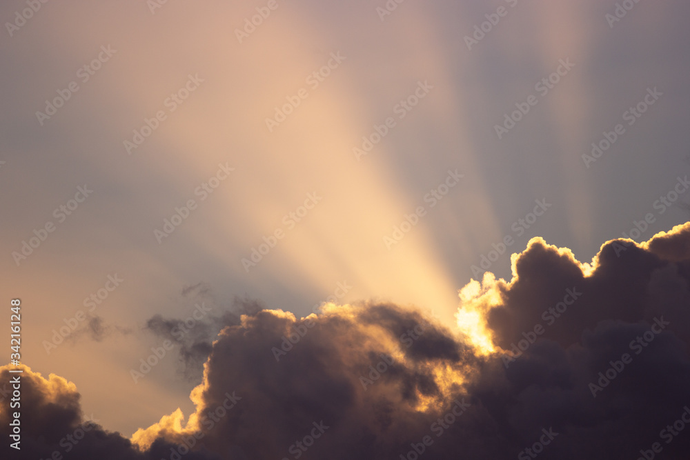 sunset rays behind the clouds