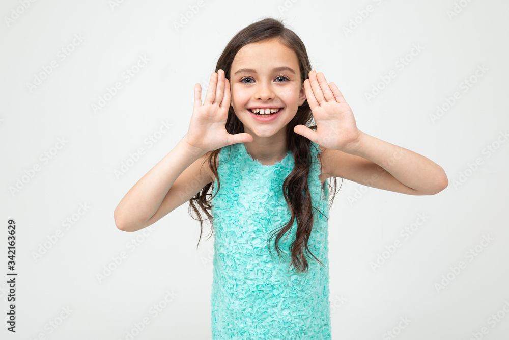 teenager girl in a blue dress shouting news on a white studio background teenager girl in a blue dress shouting news on a white studio background