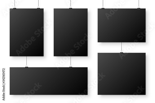 Realistic blank paper sheets hanging on binder clip. Black poster with shadow in A4 format. Design template, mockup. Vector illustration.