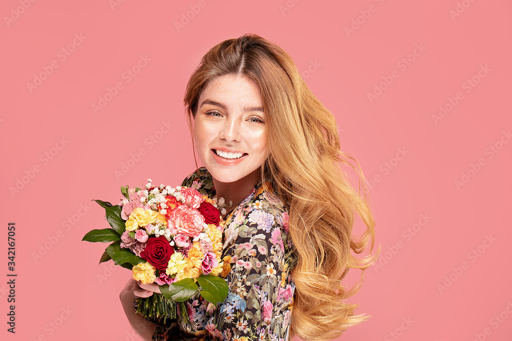 Smiling woman with flowers in hand Smiling woman with flowers in hand