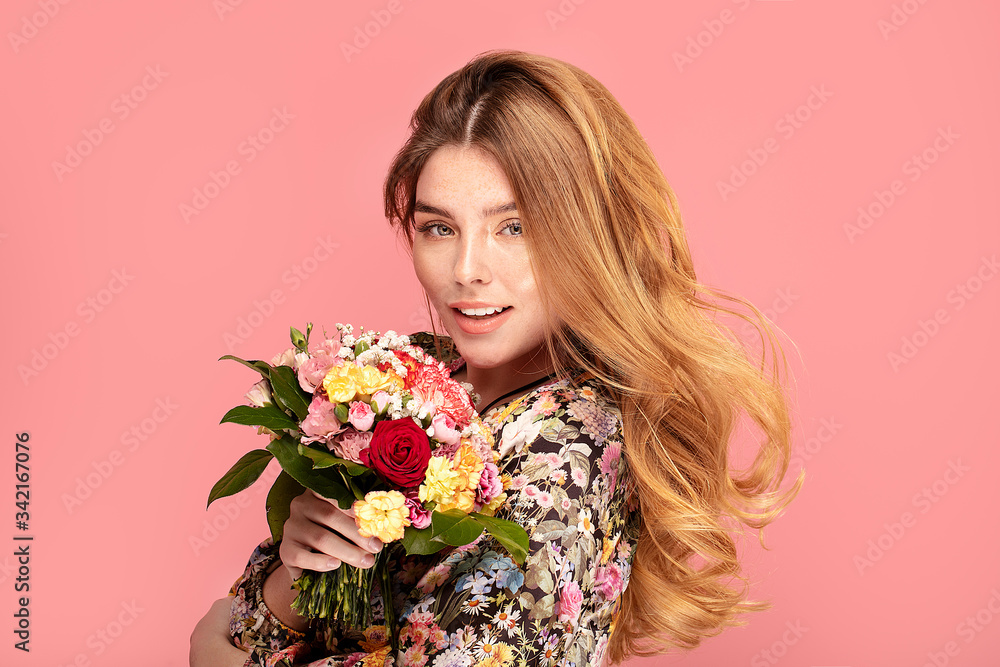 Smiling woman with flowers in hand Smiling woman with flowers in hand