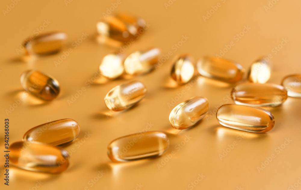 Many capsules Omega 3 on yellow background. Close up, high resolution product. Health care concept. Many capsules Omega 3 on yellow background. Close up, high resolution product. Health care concept.