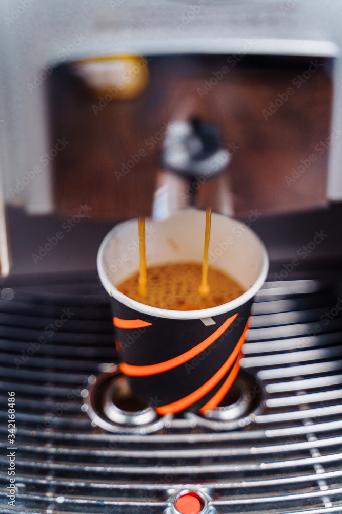 The budget model of the coffee machine prepares a delicious, fragrant espresso. Freshly brewed coffee is poured from the coffee machine into cup in the kitchen at home The budget model of the coffee machine prepares a delicious, fragrant espresso. Freshly brewed coffee is poured from the coffee machine into cup in the kitchen at home