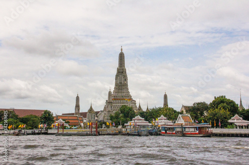 Bangkok Wat Arun Temple with river and boats in the middle