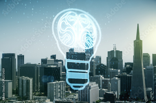 Abstract virtual creative light bulb with human brain hologram on San Francisco office buildings background, artificial Intelligence and neural networks concept. Multiexposure