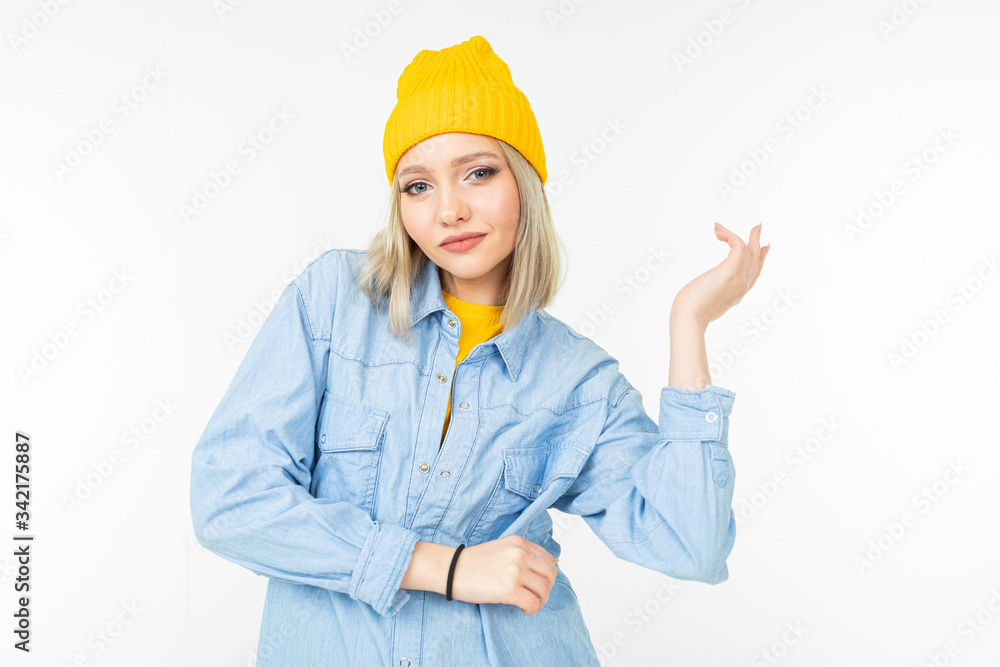 cool stylish girl in a blue shirt and yellow sweater posing on a white background cool stylish girl in a blue shirt and yellow sweater posing on a white background