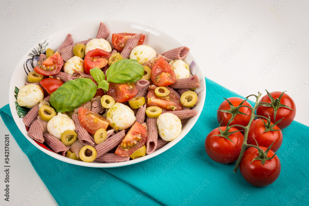 Pasta salad with mozzarella and cherry tomatoes, basil Pasta salad with mozzarella and cherry tomatoes, basil