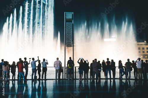 Pedestrians at Dubai Fountain at night Dubai - UAE