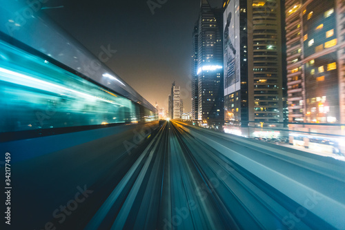metro with skyline at night Dubai - UAE
