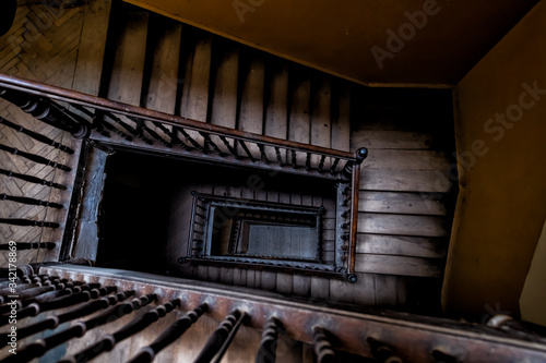 High angle aerial above view down of old vintage staircase winding spiral in Lviv, Ukraine, Europe with nobody architecture dark low-key abstract pattern