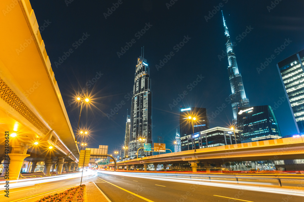 Long exposure of cars passing on highway in front of Burj Khalifa Dubai - UAE
