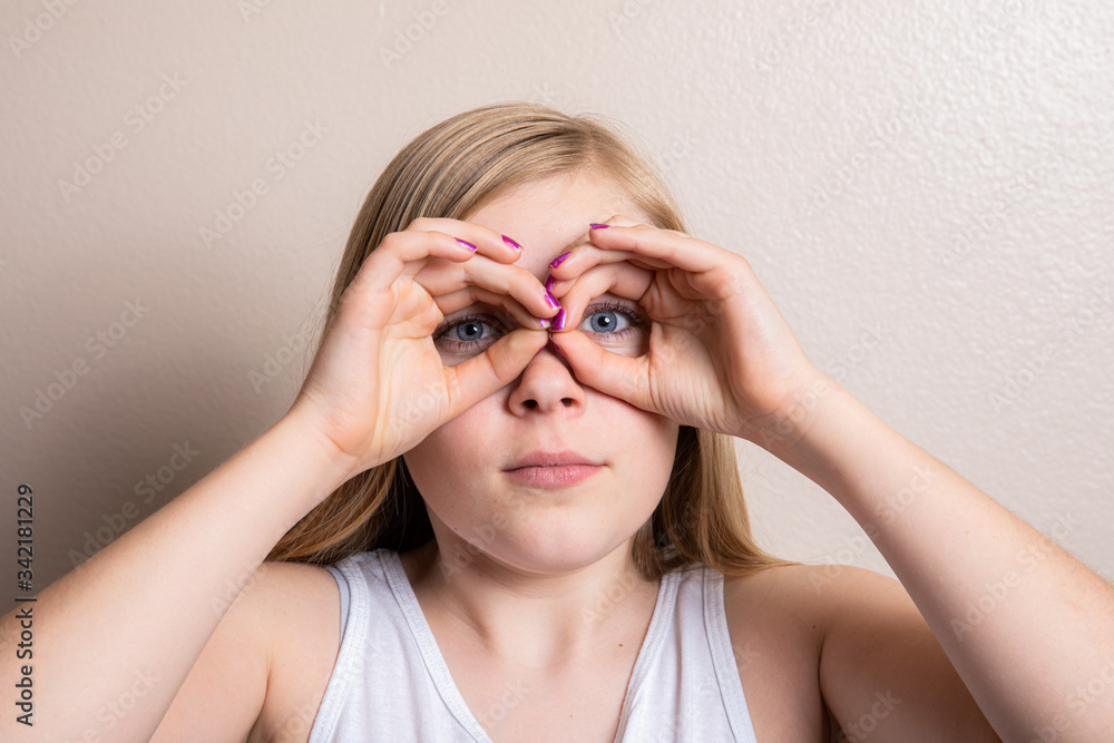 Young girl pretending to look through binoculars Young girl pretending to look through binoculars
