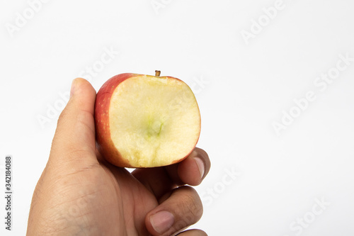 Man hand with a bite of Fresh apple isolate on white background.
