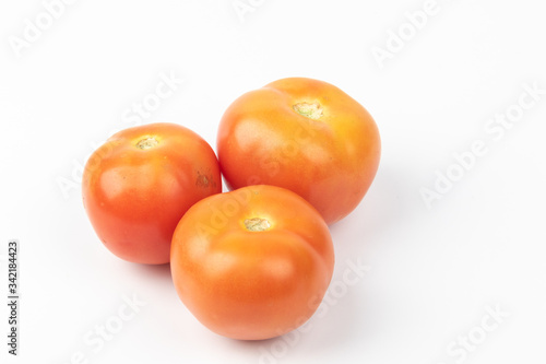 Fresh raw tomato isolated on white background.