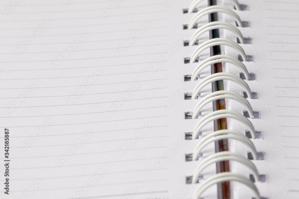 Close up School book page. White empty paper spiral notebook Close up School book page. White empty paper spiral notebook