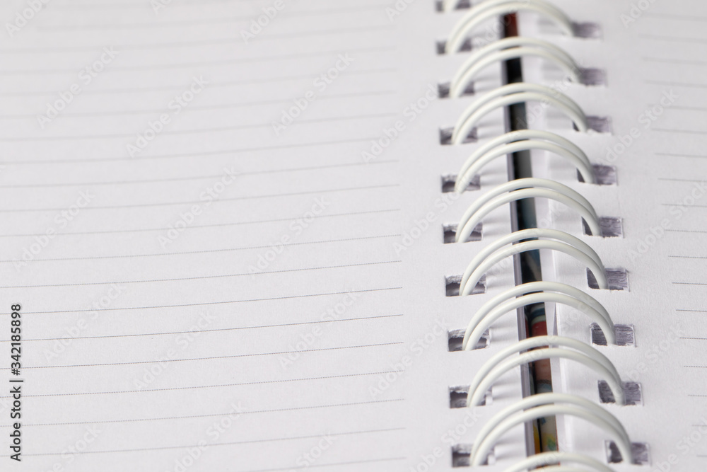 Close up School book page. White empty paper spiral notebook Close up School book page. White empty paper spiral notebook