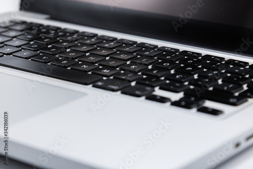 Computer keyboard in shades of black with white background.