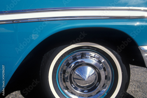 A side wheel and panel of a blue 1956 Chevrolet © spiritofamerica