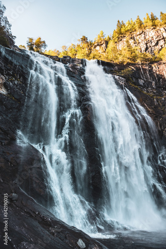 Skjervsfossen norwegian landmark high powerful cascade waterfall. Nature travel clean falling water vertical landscape  photo