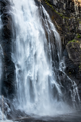 Skjervefossen waterfall falling blur water close vertical wallpaper. Norway nature Skjervet journey view powerful white sparkle silky stream 