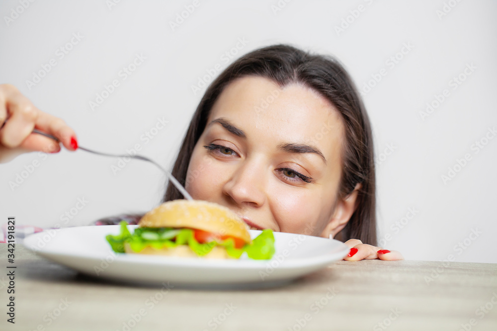 Woman eat harmful food that contributes to excess weight. Woman eat harmful food that contributes to excess weight.