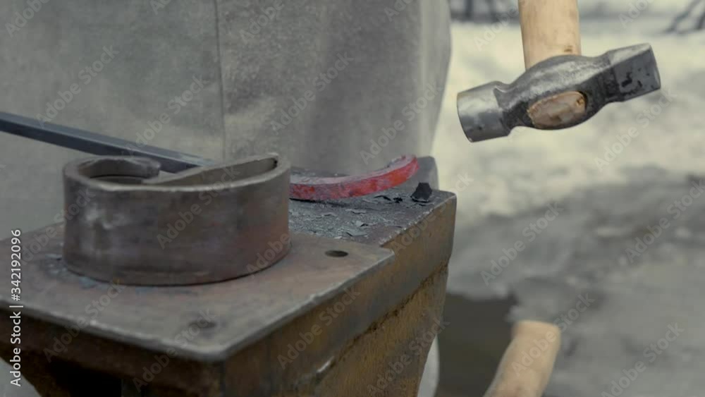 A blacksmith at work, forges hot metal. Metal Workshop A blacksmith at work, forges hot metal. Metal Workshop