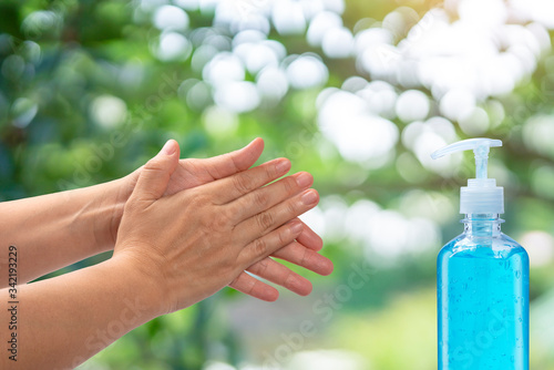 Women Hand use alcohol gel on blur background, Washing your hands for protection against infectious virus, bacteria, germs and covid-19