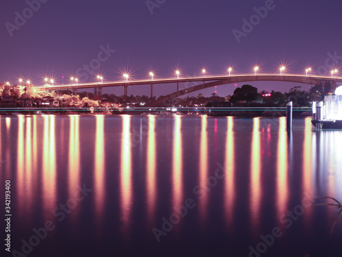 Night Long exposure of Gladesville Bridge in Sydney Australia illuminated by the bright lights and smooth harbour waters light up 