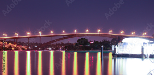 Night Long exposure of Gladesville Bridge in Sydney Australia illuminated by the bright lights and smooth harbour waters light up  photo