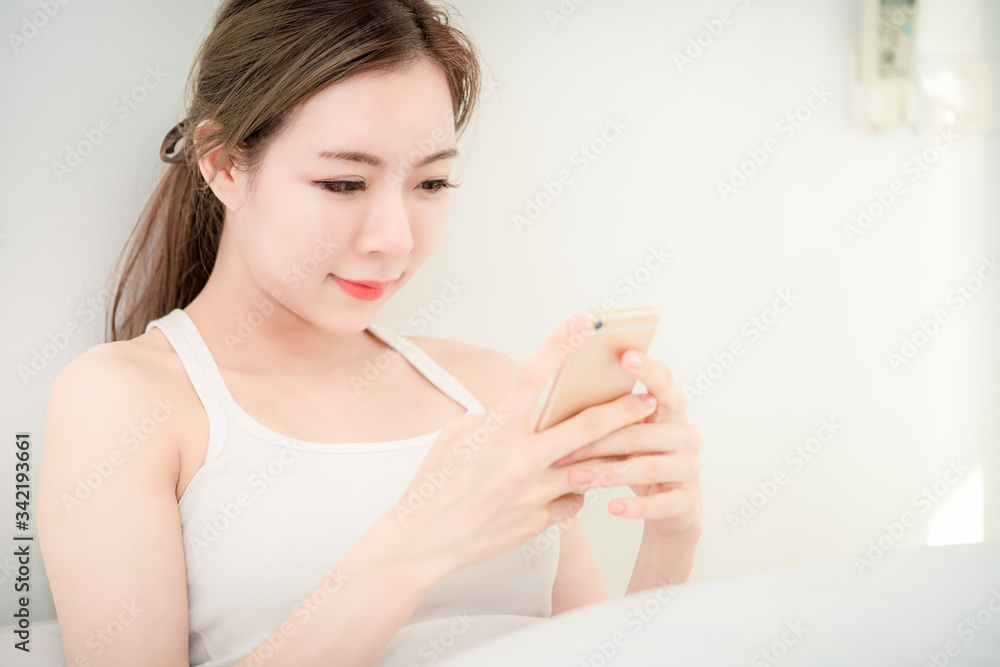 Young beautiful asian girl look at mobile smart phone with copy space using as background business technology, shopping online concept. Young beautiful asian girl look at mobile smart phone with copy space using as background business technology, shopping online concept.