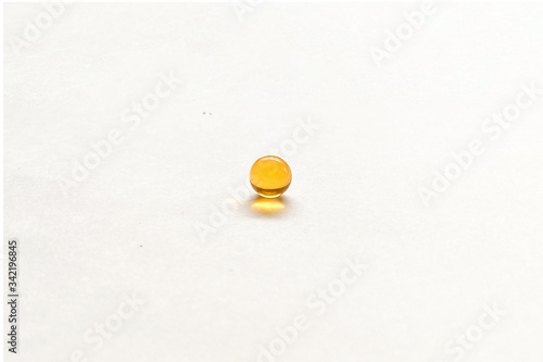 Fish oil capsule isolated on white background. Ball of fish oil on a white background
