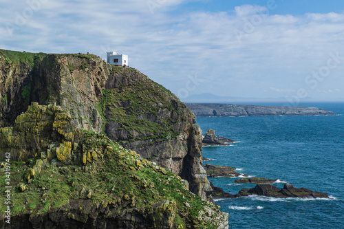 Dramatic scenery of the coast consisting of cliffs and a white house